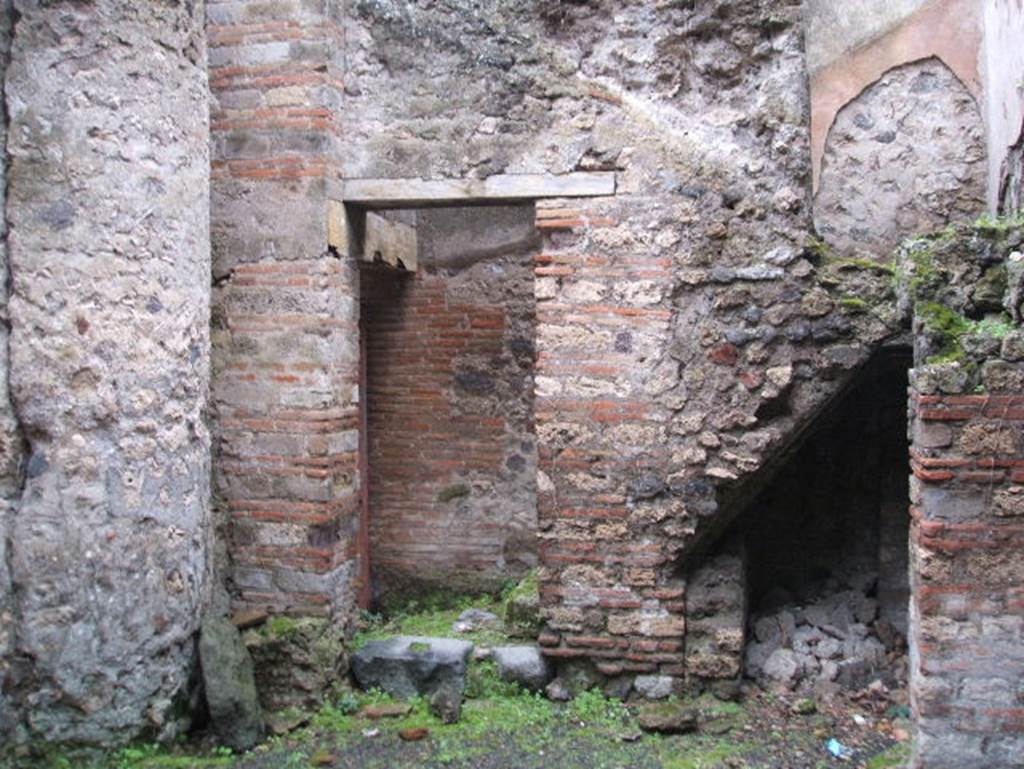 VIII.2.38 Pompeii. December 2004. Looking south to doorway to Kitchen and Steps to upper floor, with recess below.