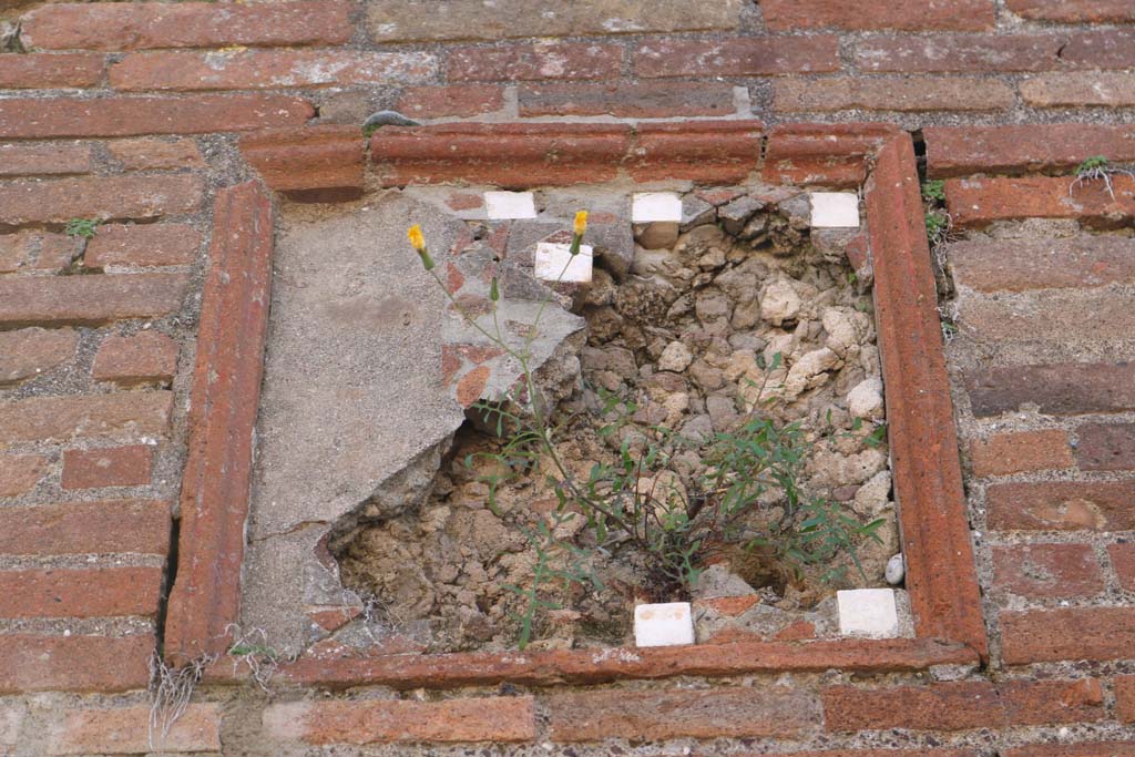 VIII.3.6 Pompeii, on left, and VIII.3.5, on right. December 2018. 
Detail of plaque on pilaster between doorways. Photo courtesy of Aude Durand.
