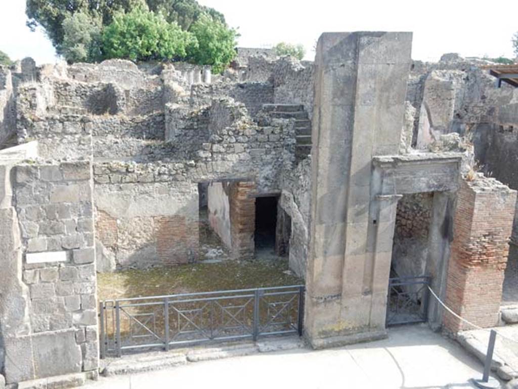 VIII.3.11, on left, Pompeii. May 2015. Looking south to entrance doorway. Photo courtesy of Buzz Ferebee.
According to Fiorelli –
Next to the stairs was a shop which was linked to the stairs (at VIII.3.10).
The shop was part of the house found at its rear (VIII.3.12), whose entrance doorway was on the eastern roadway.
In the shop was a storeroom (un repositorio), and a cubiculum under the above-mentioned stairs, with the remains of various figures of Muses decorating the walls.
See Pappalardo, U., 2001. La Descrizione di Pompei per Giuseppe Fiorelli (1875). Napoli: Massa Editore. (p.124).
