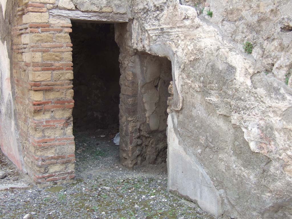 VIII.3.11 Pompeii. May 2006. South-west corner, with two doorways, one into a cubiculum, the other into a storeroom.
The cubiculum would have had white painted walls separated into panels by red lines.
