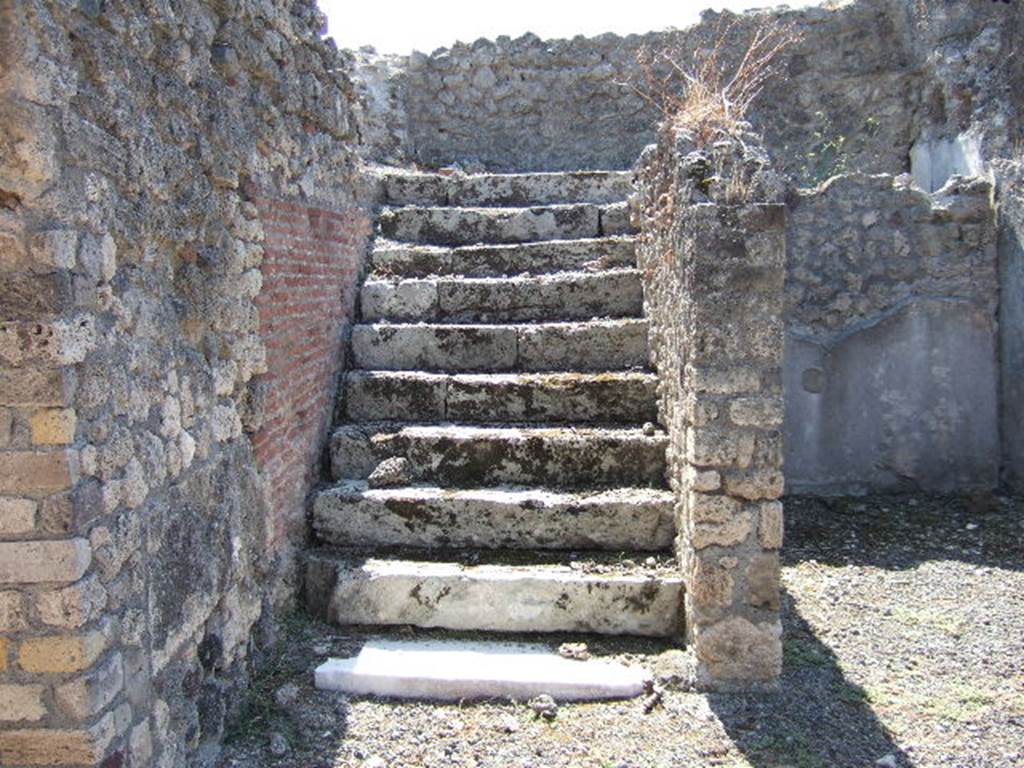 VIII.3.14 Pompeii. September 2005. Steps to upper floor in south-east corner of atrium. On the extreme left is the doorway to the kitchen, latrine and small storeroom.