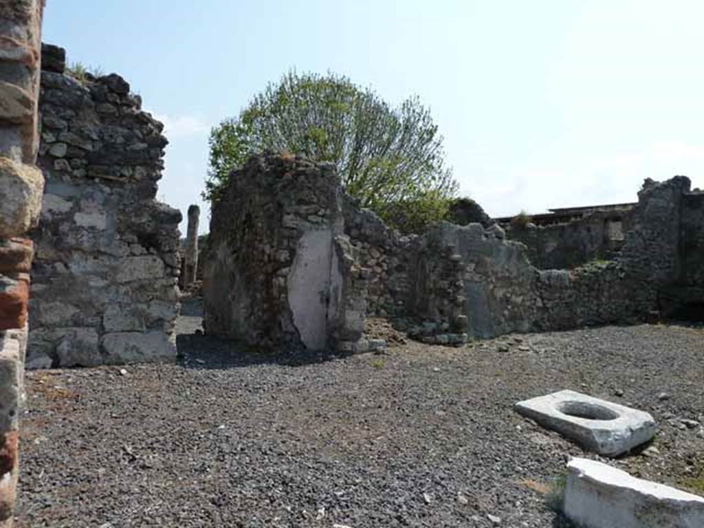 VIII.3.18 Pompeii. May 2010.   Looking east across atrium towards corridor to rear rooms and peristyle. Taken from VIII.3.19.  According to Boyce, there is a large recess formed from heavy masonry walls (in the centre of the photo). Fiorelli called it simply a recess to contain a cupboard, but Breton thought it was the lararium. According to Boyce, it may well have been a lararium.