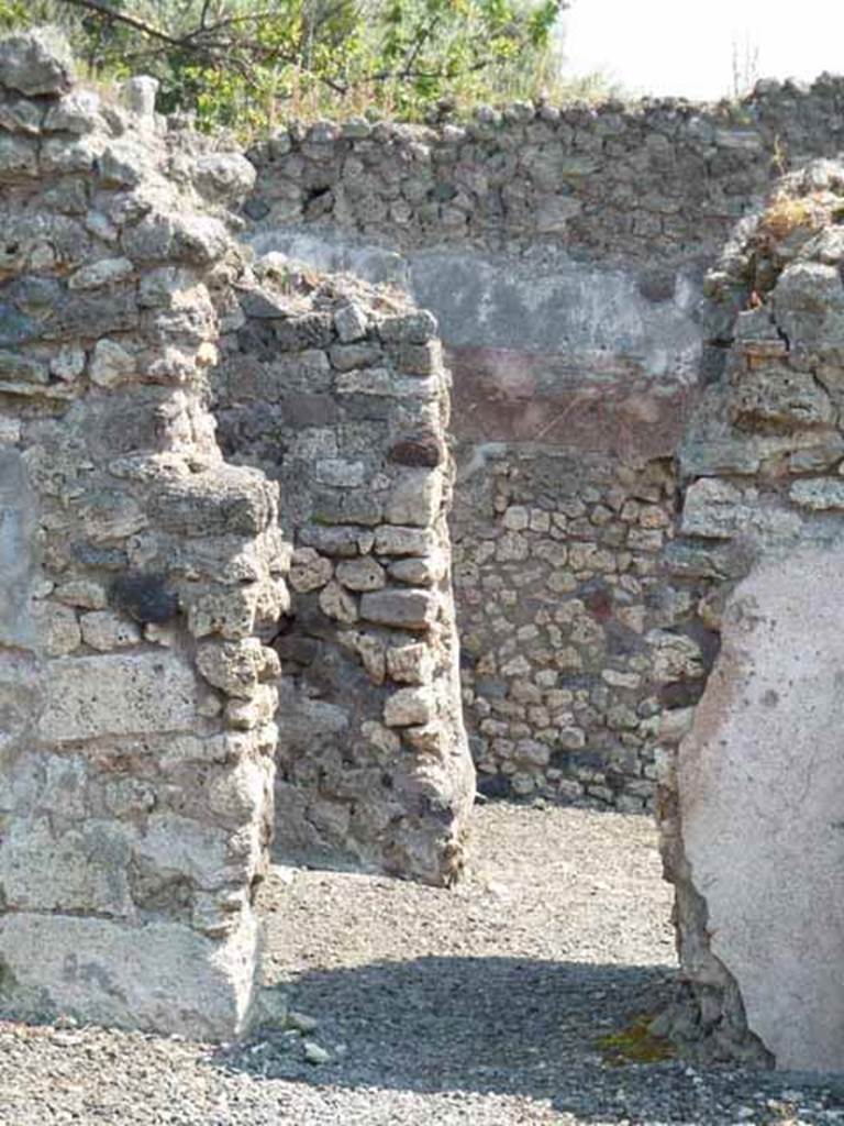 VIII.3.18 Pompeii. May 2010. Doorway from atrium to rooms in north-east corner, leading to peristyle near VIII.3.16. Found in the north ala, (the room on the left in the front of the photo), was a painting showing a sitting male figure with a female figure. This was thought to be Diana (see Helbig 257) or perhaps Atalanta with Meleager, according to Schefold.
The house was named from the painting of Diana.
See Helbig, W., 1868. Wandgemälde der vom Vesuv verschütteten Städte Campaniens. Leipzig: Breitkopf und Härtel. (257)
See Schefold, K., 1957. Die Wände Pompejis. Berlin: De Gruyter. (p.221)