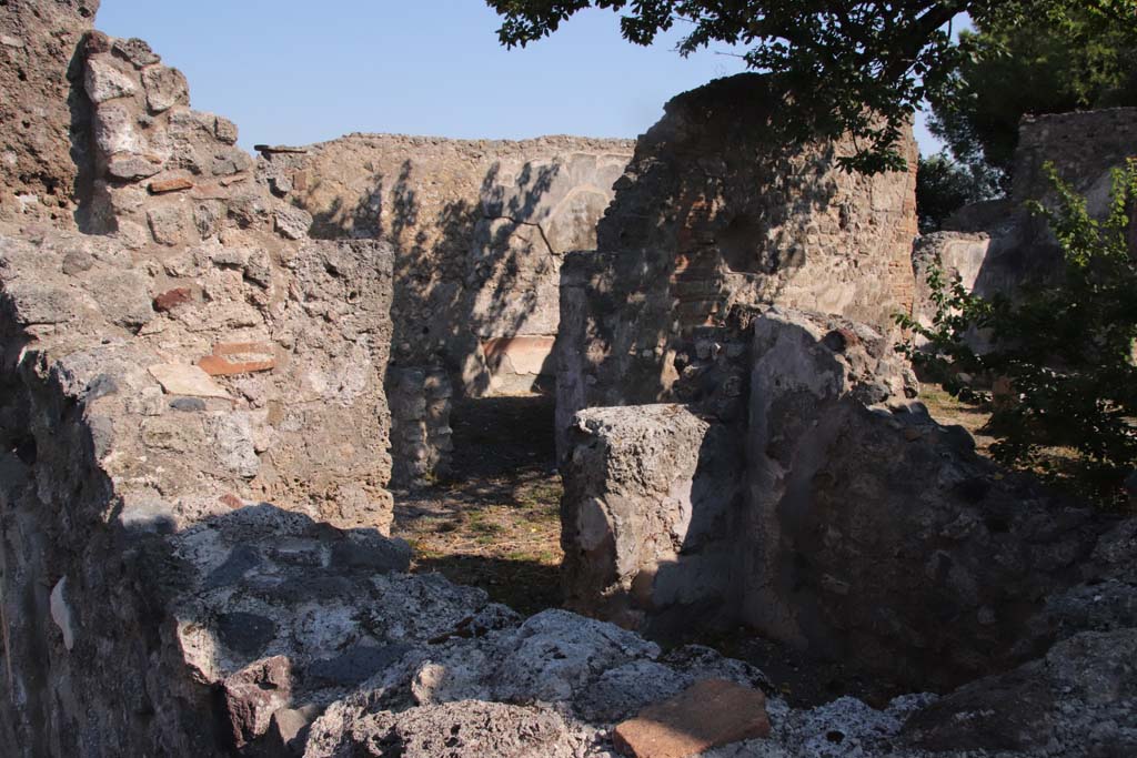 VIII.3.21 Pompeii. September 2021. Looking north-east to rear of house, through doorway and walls of room (3). 
North wall of triclinium (6) can be seen in the centre through the doorway of room (3).
Room (4), with niche in its north wall but in shadow, can be seen on the right. Photo courtesy of Klaus Heese.