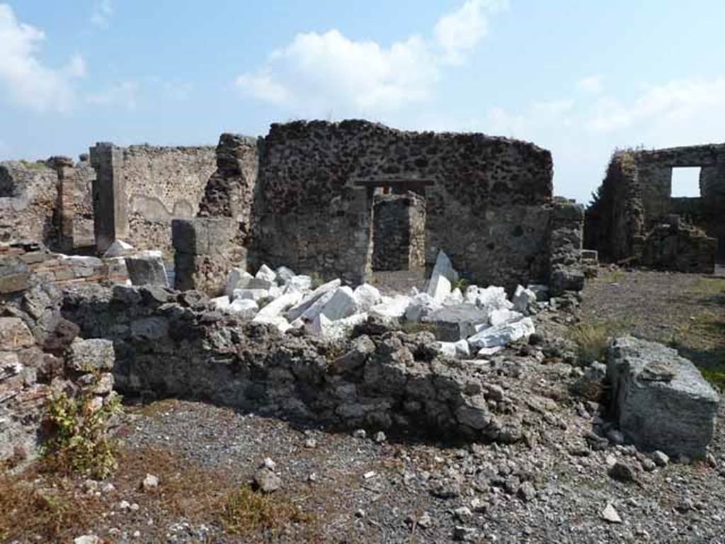 VIII.3.31 Pompeii. May 2010. Looking east across small room or cupboard in the north-west corner of the portico, towards the oecus with two doorways.  Taken across the wall of VIII.3.29.
