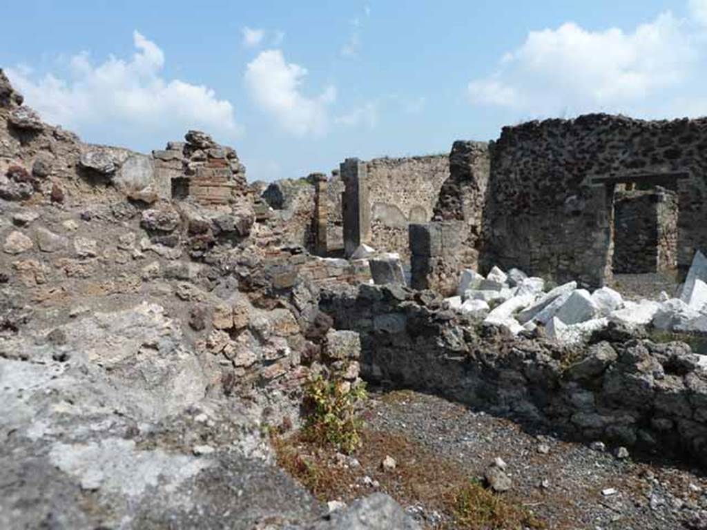 VIII.3.31 Pompeii. May 2010. Looking north-east across small room or cupboard, towards the oecus with two doorways. Taken across the wall of VIII.3.29.