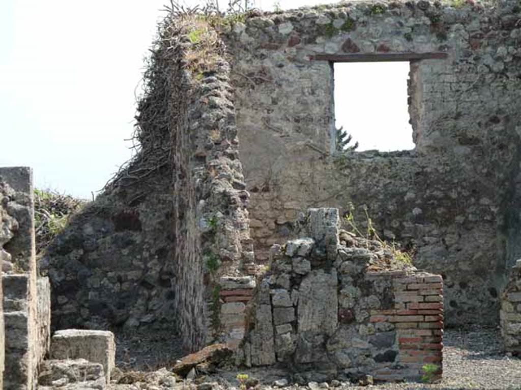 VIII.3.31 Pompeii. May 2010. On the left, the corridor to an exedra, two cubicula, the kitchen and latrine.  According to Fiorelli, found in the exedra reached by the corridor, was a landscape painting showing Hercules and Telamon freeing Hesione. Nothing remains other than the description by Helbig. On the right a large exedra with window. Taken across the wall of VIII.3.29.
See Fiorelli, G., 1875. Descrizione di Pompei, Napoli, (p.331)
See Helbig, W., 1868. Wandgemälde der vom Vesuv verschütteten Städte Campaniens. Leipzig: Breitkopf und Härtel. (H 1131)
