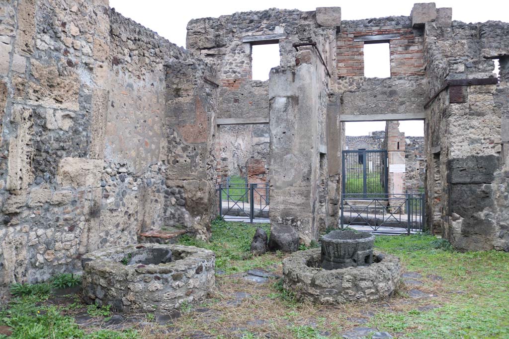 VIII.4.26 Pompeii, on left, and VIII.4.27, on right. December 2018. 
Looking east across bakery towards entrance doorways onto Via Stabiana. Photo courtesy of Aude Durand.