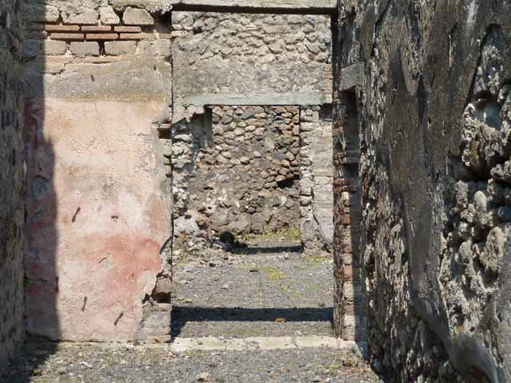 VIII.4.33 Pompeii. May 2010. Doorway at north end of entrance corridor leading into courtyard on west side of peristyle. Ahead can also be seen the doorway to a cubiculum on the north side.