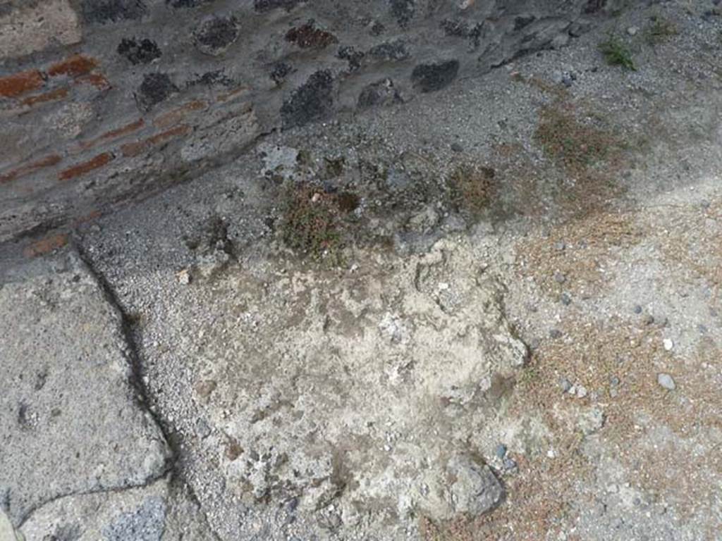 VIII.4.35 Pompeii, September 2015. Flooring near doorway threshold, possibly remains of base-steps to upper floor, in south-west corner of shop-room.