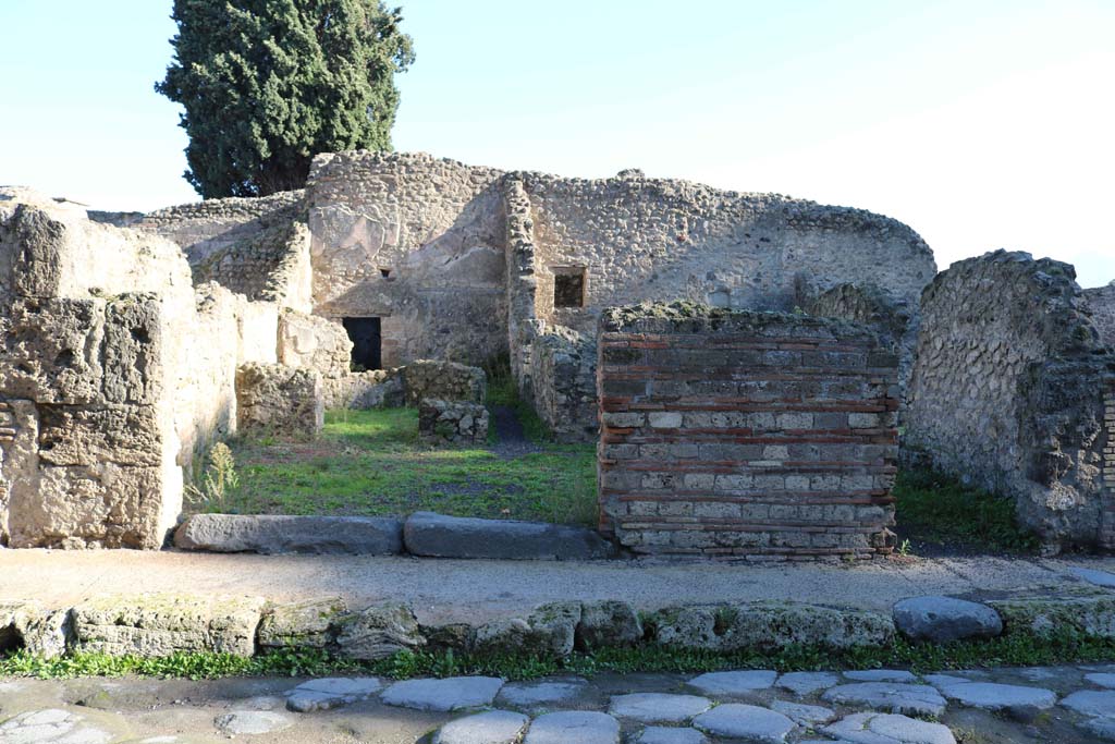 VIII.4.44 Pompeii, on left, and VIII.4.43. December 2018. Looking east to entrances on Via dei Teatri. Photo courtesy of Aude Durand.