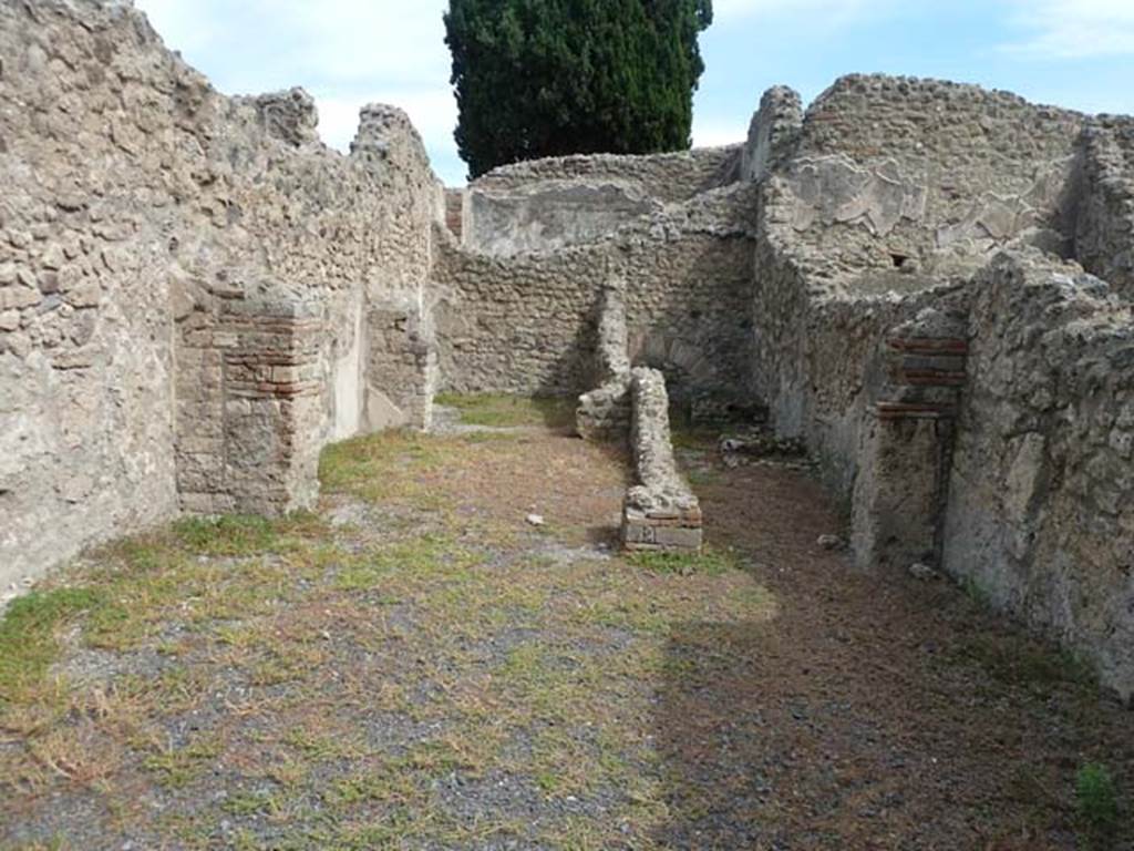 VIII.4.45 Pompeii. September 2015. Looking east from entrance doorway across shop-room, towards two rooms on left, one behind the other. On the right, the corridor to the rear leading to a kitchen, latrine and steps to upper floor.