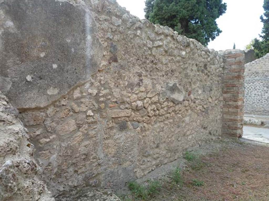 VIII.4.46 Pompeii. September 2015. Looking west along south wall towards shop-room entrance.
