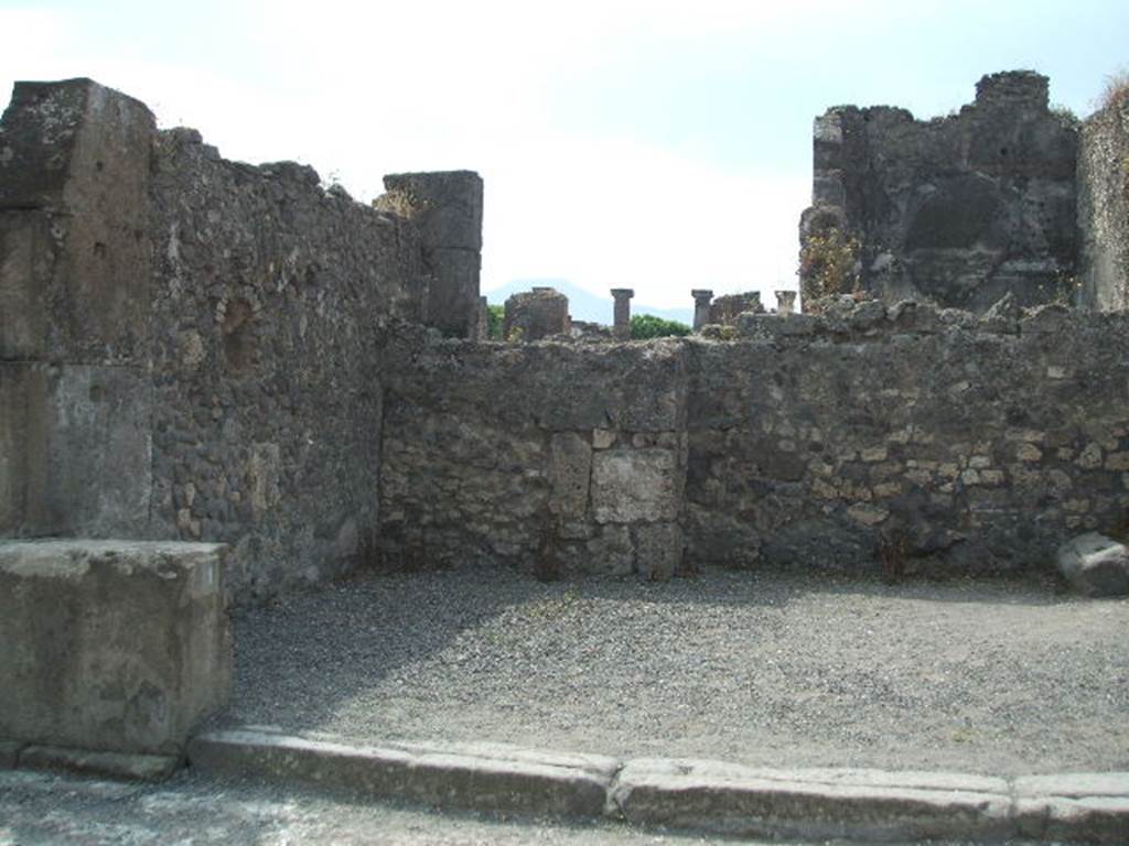 VIII.5.1 Pompeii. May 2005. East side of shop, with niche in east wall.
According to Boyce, the arched niche was called by Fiorelli “la nicchia dei Penati”.
See Boyce G. K., 1937. Corpus of the Lararia of Pompeii. Rome: MAAR 14. (p.76, no.364) 
See Pappalardo, U., 2001. La Descrizione di Pompei per Giuseppe Fiorelli (1875). Napoli: Massa Editore. (p.163).
According to Fiorelli, this shop originally had a doorway at the rear, that would have linked it with the atrium of VIII.5.2, but then was blocked up.
See Fiorelli, G. (1875). Descrizione di Pompei, (p.446).