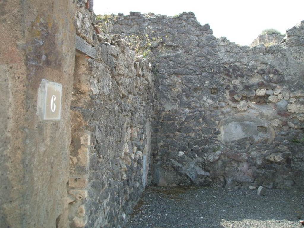 VIII.5.6 Pompeii. May 2005. East wall with communicating doorway to VIII.5.7, and south wall.  According to Hobson, a wall scar of a down-pipe can be seen in the south-east corner of the shop. See Hobson, B., 2009. Pompeii, Latrines and Down Pipes. Oxford, Hadrian Books. (p.460).