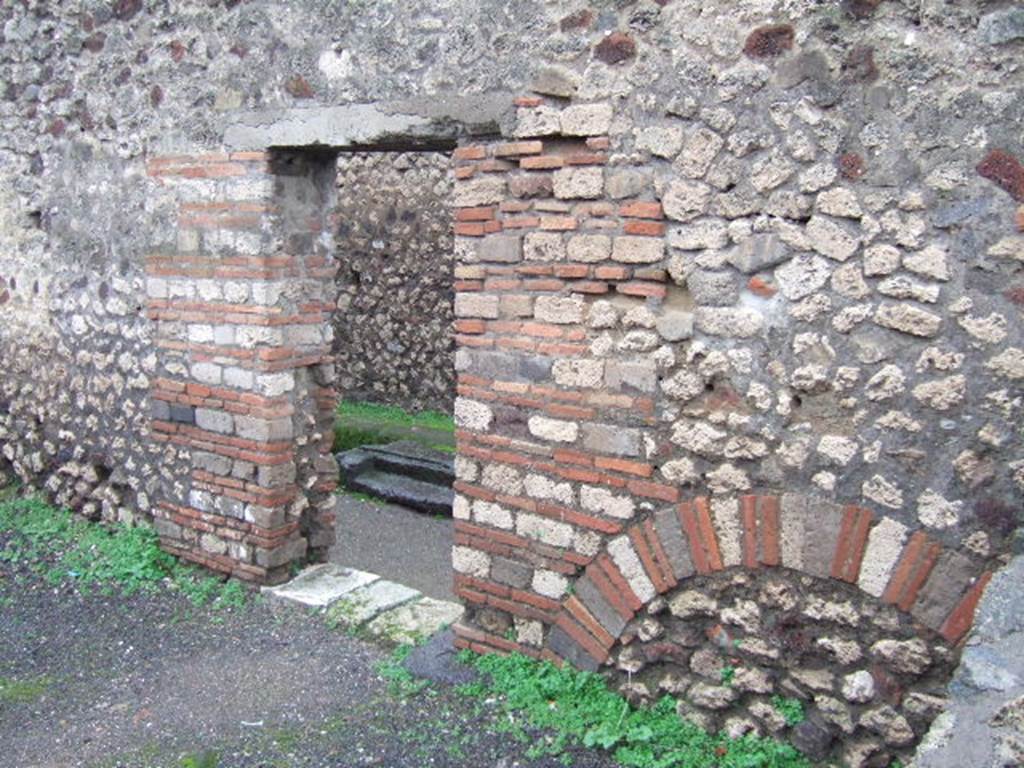 VIII.5.17 Pompeii. December 2005. West wall with doorway, looking into small vicolo.