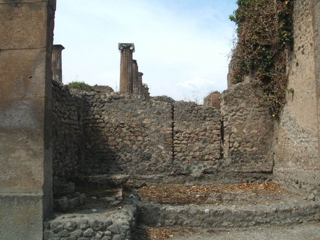 VIII.5.34 Pompeii. May 2005. Looking west towards entrance, and blocked doorway to VIII.5.28. On the left can be seen the base of the stairs to the upper floor.