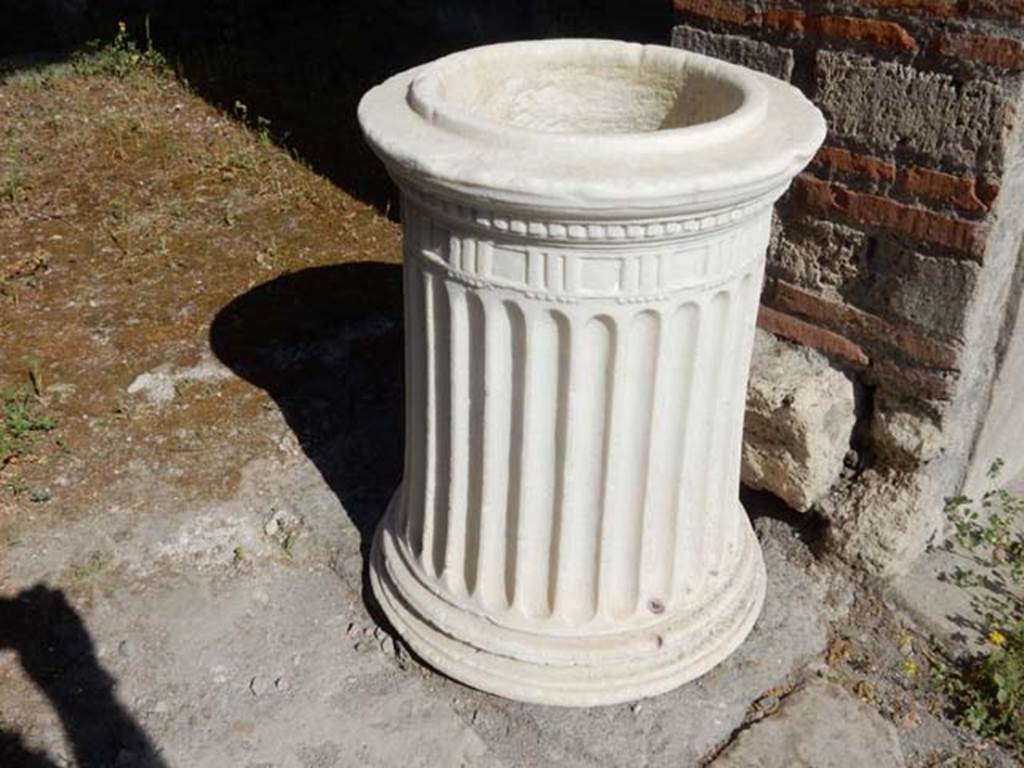 VIII.5.37 Pompeii. May 2017. Puteal in doorway of room 5. Photo courtesy of Buzz Ferebee. This travertine puteal would have originally been above the cistern mouth in the atrium. It is grooved and adorned with a Doric frieze with a cornice, and dated back to the Republican age.