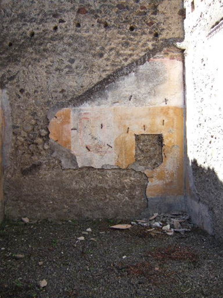 VIII.5.39 Pompeii. September 2005. Room 5, west wall.
According to PPM – The IV Style decoration is better preserved on this wall.
The central panel was white, the side panels were yellow edged with a border of “carpet” design; 
the one on the right (north end) contained a medallion showing the head of a young girl – now taken off
The zoccolo would have been black with painted plants.
See Carratelli, G. P., 1990-2003. Pompei: Pitture e Mosaici: Vol. VIII. Roma: Istituto della enciclopedia italiana, p. 659.
