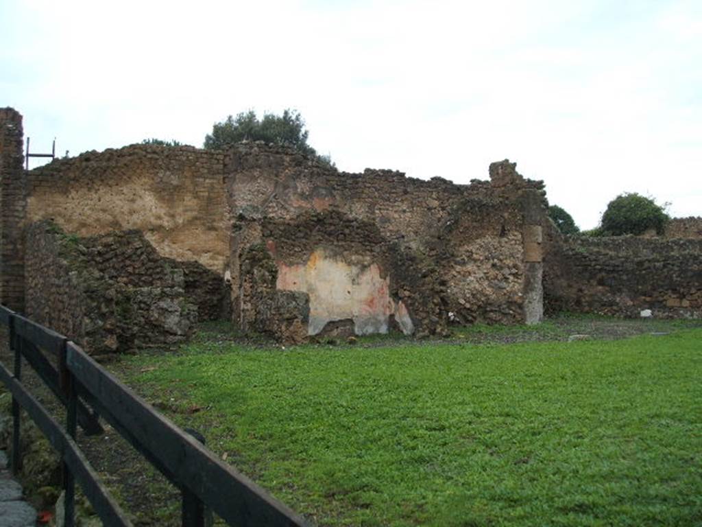 VIII.6.3 Pompeii. December 2004. Looking west. According to Boyce, on the west wall of a room which was perhaps a kitchen, was a partially preserved lararium painting. In the upper zone, the feet of the Genius, to the right of him, a Lar in red and blue tunic, again to the right a long staff, perhaps with sausages attached to it. Below the figure of the Genius, a tile was embedded in the wall to hold offerings. Below this, was a serpent (black with a yellow belly, red crest and beard) advancing towards a second serpent (smaller and all black with crest). This second serpent was coiled around a black omphalos covered with a green net and standing upon a rectangular base. See Boyce G. K., 1937. Corpus of the Lararia of Pompeii. Rome: MAAR 14. (p.78, no.373) 
According to Giacobello, the picture on the west wall of kitchen has not been conserved. The small service area was located in the south-west corner of the house. See Giacobello, F., 2008. Larari Pompeiani: Iconografia e culto dei Lari in ambito domestico.  Milano: LED Edizioni. (p.204)