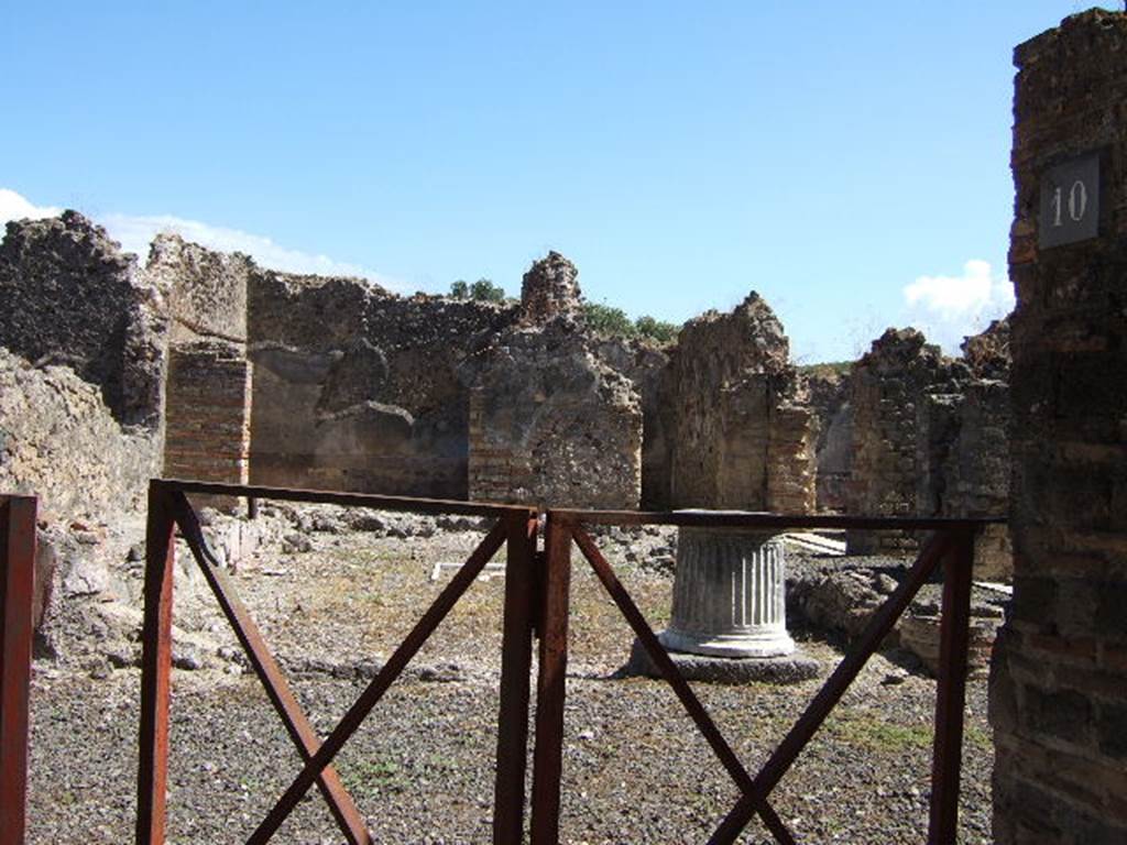 VIII.6.10 Pompeii. September 2005. Looking east from entrance into area of peristyle.
According to Mau, the dwelling of the owner of the bakery was placed around the peristyle.
It had a separate entrance doorway from the western roadway, preceded by a step covered with roof tiles, one of which had a stamp mark. See BdI, 1884, p.182.
According to Jashemski, the area was not a garden but had a pavement of opus signinum.
The area was enclosed on all four sides by a portico, supported by three columns on the north and south. The columns were painted black below, and red above. Today, only the bases of the columns remain. In the middle of the paved area, according to the reports, there was a rectangle lined with pieces of white and grey marble, in which pieces of yellow marble formed a cross. In the centre of the cross was a little yellow square bordered by a narrow red stripe.  Today it is much damaged. The various rooms of the house opened off the portico, which could be entered directly from the street at VIII.6.9.  The atrium at the front of the house had been converted into a bakery, VIII.6.1.
See Jashemski, W. F., 1993. The Gardens of Pompeii, Volume II: Appendices. New York: Caratzas. (p.219)