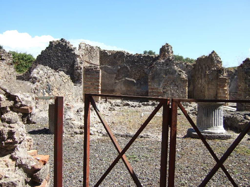 VIII.6.10 Pompeii. September 2005. Looking east from entrance into area of peristyle.
According to Mau, upon entering the doorway, found on the right on the entrance wall was a “boss” in the guise of a pillar. It was 1.40m wide, 0.30 deep, and 1.15m high.
It conserved remains of a coating of marble, and on the wall above were the remains of a lararium painting: it was clear, therefore, that this boss served as an altar for offerings to the domestic gods. However, it seemed in the last times it was destroyed, and that a cylindrical tufa altar (0.32 high, 0.28 diameter) was used instead, this was still lying in the same corner. See BdI, 1884, p.183
(Appena entrati troviamo a destra al muro d'ingresso una sporgenza a guisa di pilastro: è larga m. 1,40, profonda 0,30, ed era alta 1,15. Conserva avanzi d'un rivestimento di marmo, e sulla parete sovrastante sonvi quelli della pittura lararia: è chiaro dunque che questa sporgenza serviva da altare per le offerte ai Lari. Pare però che negli ultimi tempi fosse distrutta e che invece si servissero d'un'aretta cilindrica di tufo (a. 0,32, diam. 0,28) che tuttora si trova nell'angolo stesso).
According to Boyce, there was a projecting base against the wall to the right of the entrance from the street, into the peristyle. (not photographed yet). Traces of the original covering with slabs of marble could be seen. Above it were the remains of the vanished lararium painting. The top of the pilaster may have served as an altar for offerings. Found nearby was a small cylindrical altar of tufa. Mau thought this may have been used instead of the pilaster top, during the last days of the city. Boyce’s reference - Bull.Inst, 1884, 183.
See Boyce G. K., 1937. Corpus of the Lararia of Pompeii. Rome: MAAR 14. (p.78, no.375)
