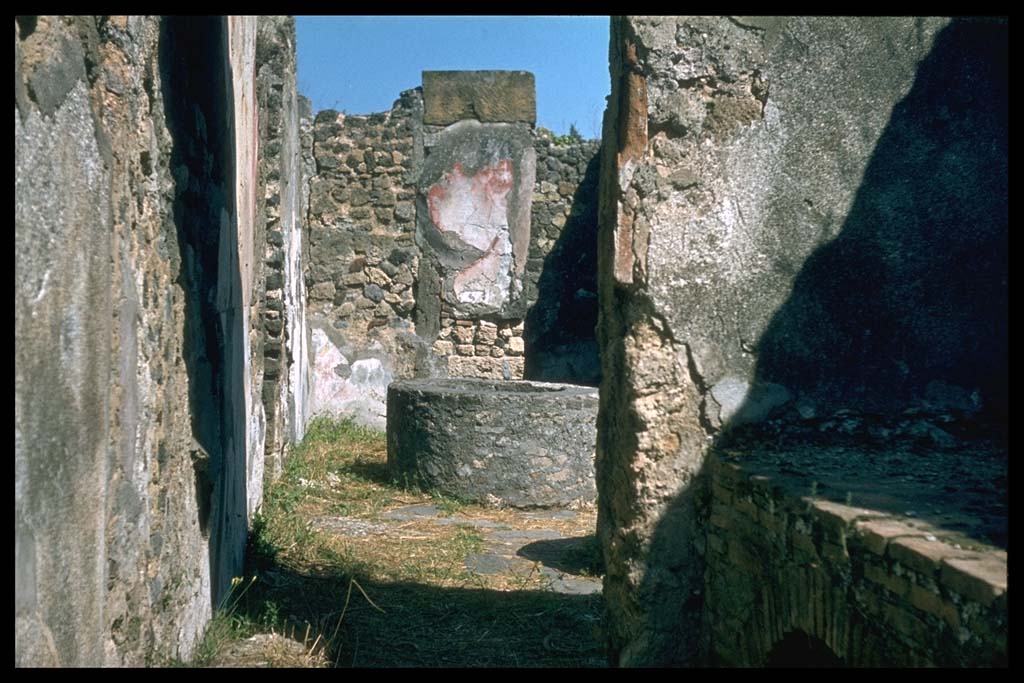 VIII.6.11 Pompeii. Looking east towards bakery from kitchen with hearth.
Photographed 1970-79 by Günther Einhorn, picture courtesy of his son Ralf Einhorn.
According to Mau, the threshold of the kitchen doorway apparently was made of wood.
See Bullettino dell’Instituto di Corrispondenza Archeologica (DAIR), 1884, p.139