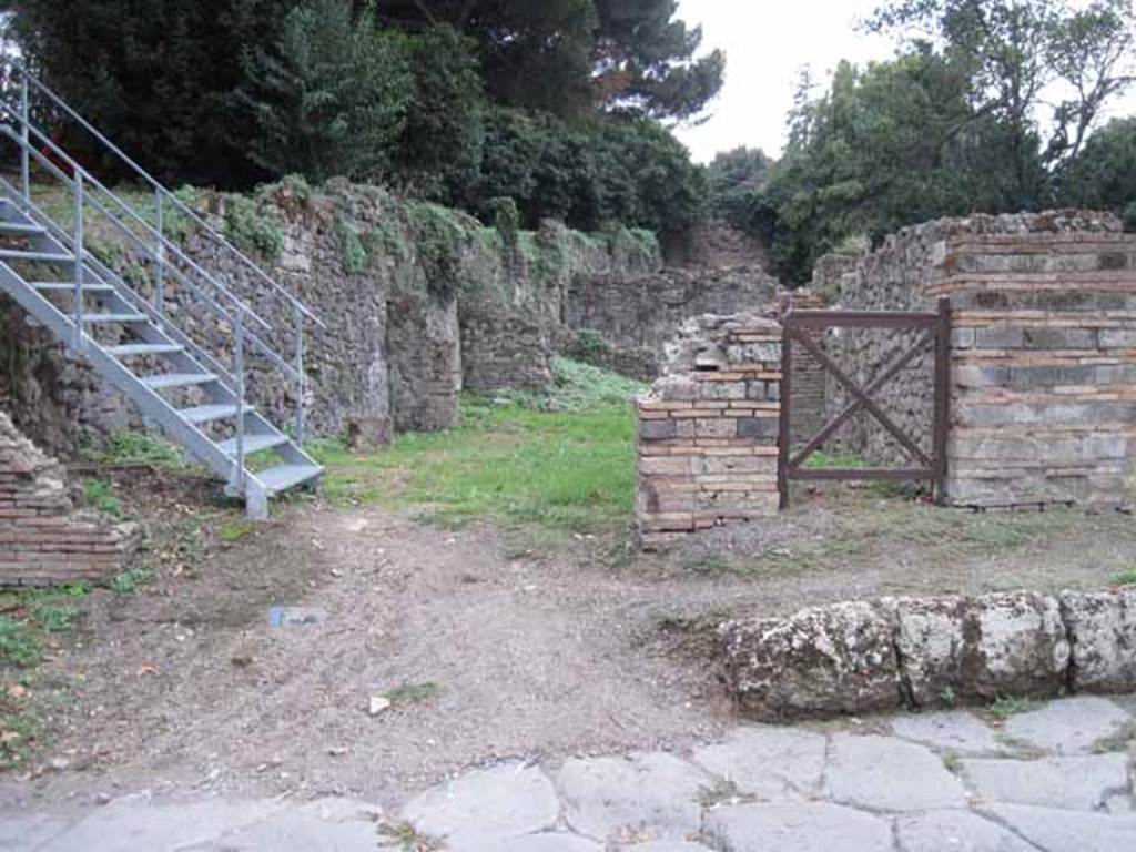VIII.7.1 Pompeii. September 2010. Entrance on Via Stabiana, looking west (across street). VIII.7.1 entrance is left of the square gate.  Photo courtesy of Drew Baker.