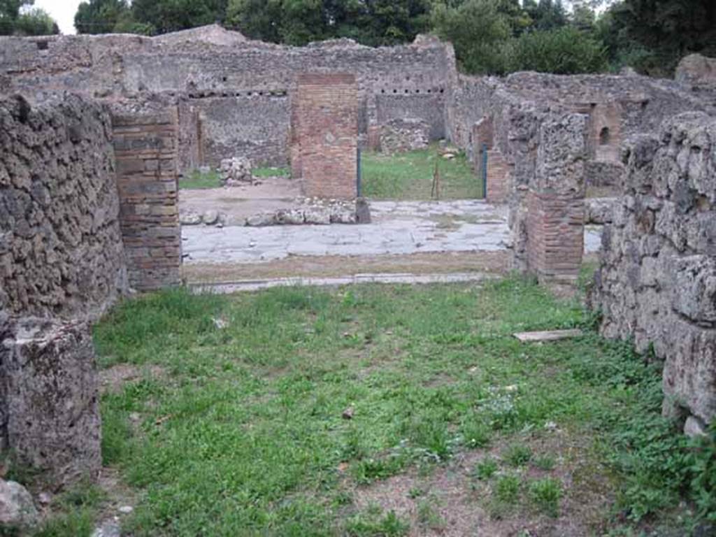 VIII.7.4 Pompeii. September 2010. Looking east from rear room across shop to entrance on Via Stabiana. Photo courtesy of Drew Baker.
According to Mau in BdI –
Note that neither of the shops (VIII.7.3 or 4) have the usual podium, and that the rear rooms are rather spacious. In the middle of the second shop (VIII.7.4) stands a graceful marble table, the support of which is adorned with a bust of a Satyr wearing a fawn’s skin (nebris). Evidently these are not really shops, but taverns, and locations of a caupona. 
(Si noti, che in nessuna delle botteghe si trova il solito podio, e che le retrobotteghe sono stanze piuttosto spaziose. In mezza alla seconda bottega sta un grazioso tavolino di marmo, il cui sostegno era adorno d’un busto di Satiro colla nebris. Evidentemente queste non sono propriamente botteghe, ma taverne, locali d’una caupona.)
See Bullettino dell’Instituto di Corrispondenza Archeologica (DAIR), 1875, p.126.