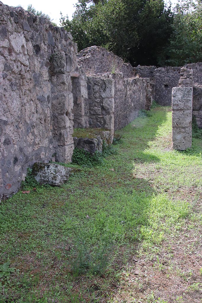 VIII.7.8 Pompeii. October 2024. 
Looking west towards corridor along south side of workshop room. Photo courtesy of Klaus Heese.