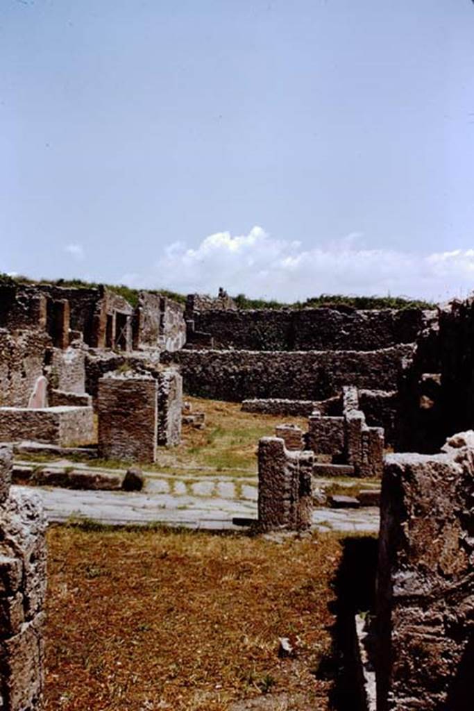 VIII.7.8 Pompeii, on left. 1966. Looking east from rear of VIII.7.8 towards Via Stabiana, with steps to upper floor at VIII.7.7, centre right. On the opposite side of Via Stabiana, I.1.8 can be seen.  Photo by Stanley A. Jashemski.
Source: The Wilhelmina and Stanley A. Jashemski archive in the University of Maryland Library, Special Collections (See collection page) and made available under the Creative Commons Attribution-Non Commercial License v.4. See Licence and use details.
J66f0200
