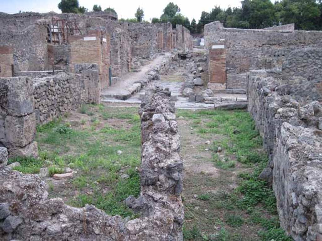 VIII.7.10 Pompeii. September 2010. 
Looking east along corridor from rear dormitory room, towards shop entrance on Via Stabiana, and Vicolo del Conciapelle, opposite.
Photo courtesy of Drew Baker.