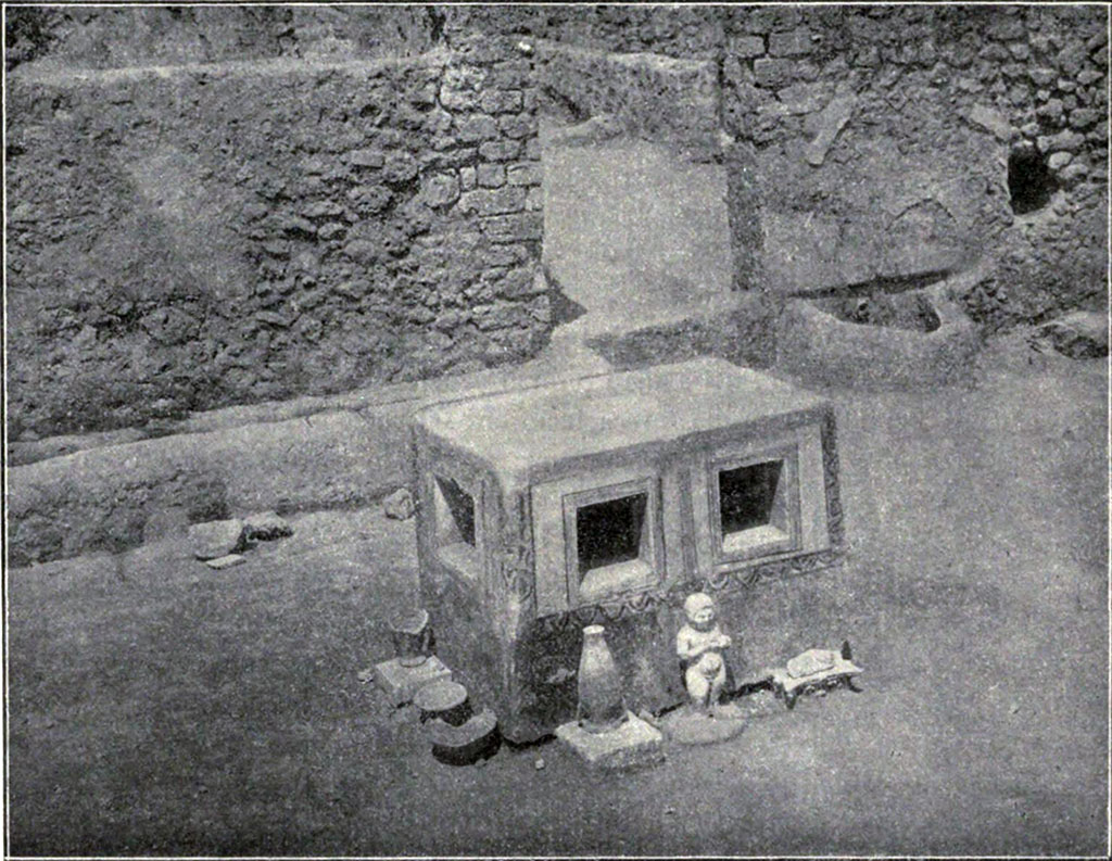 VIII.7.10 Pompeii. 1910. Detail of unusual masonry table to north of triclinium, with amphora, statuette and other objects.
According to PARP: PS (2005), this table is now totally destroyed.
See PARP: PS 2005 season report http://www.fastionline.org/docs/FOLDER-it-2005-48.pdf . (p. 3)
See Notizie degli Scavi di Antichità, 1910, p. 265-7, fig. 6.