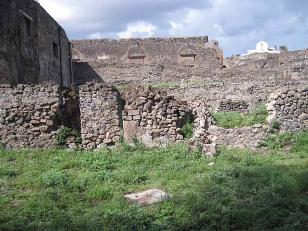 VIII.7.10 Pompeii. September 2010. 
North wall of garden area, with entrance to northern garden of VIII.7.11. Photo courtesy of Drew Baker.
The doorway has been blocked, but there is no evidence of a lava step.
According to Jashemski, attached to the north wall were two masonry basins, and between them was the opening with a lava step in front of it.
This gave entry to the garden to the north.
See Jashemski, W. F., 1993. The Gardens of Pompeii, Volume II: Appendices. New York: Caratzas. (p.221).