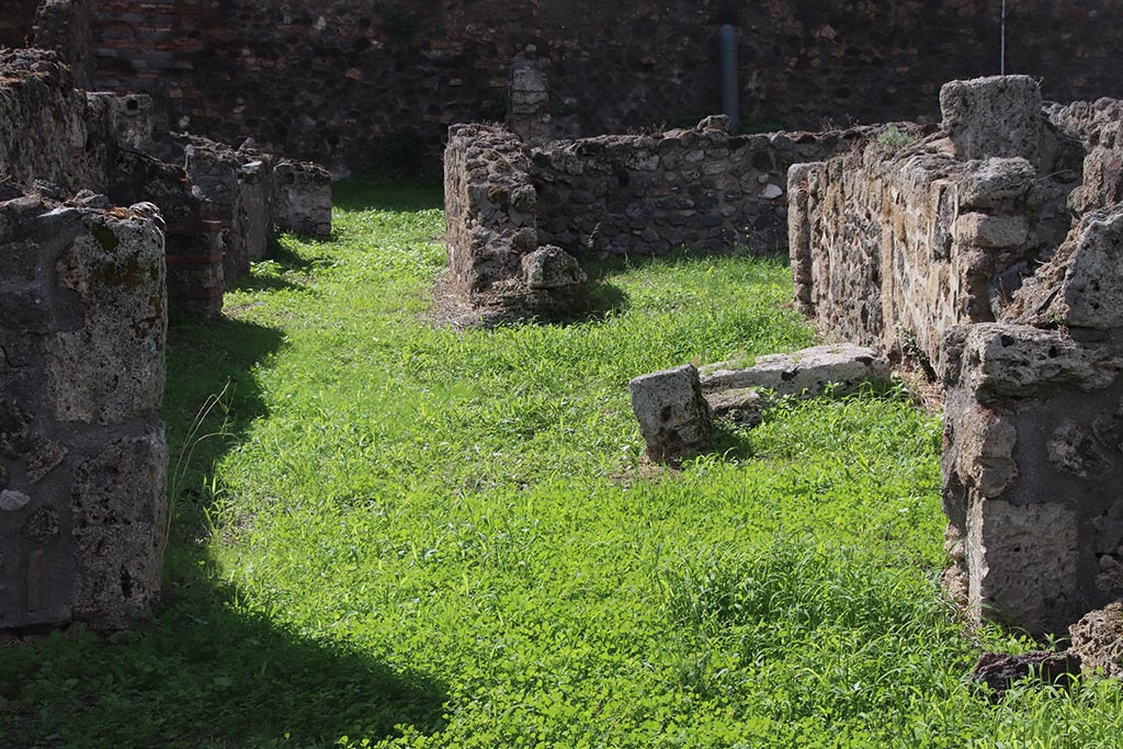 VIII.7.11 Pompeii. October 2024.
Looking west across rear room to corridor and doorway to cubiculum (on right). Photo courtesy of Klaus Heese.