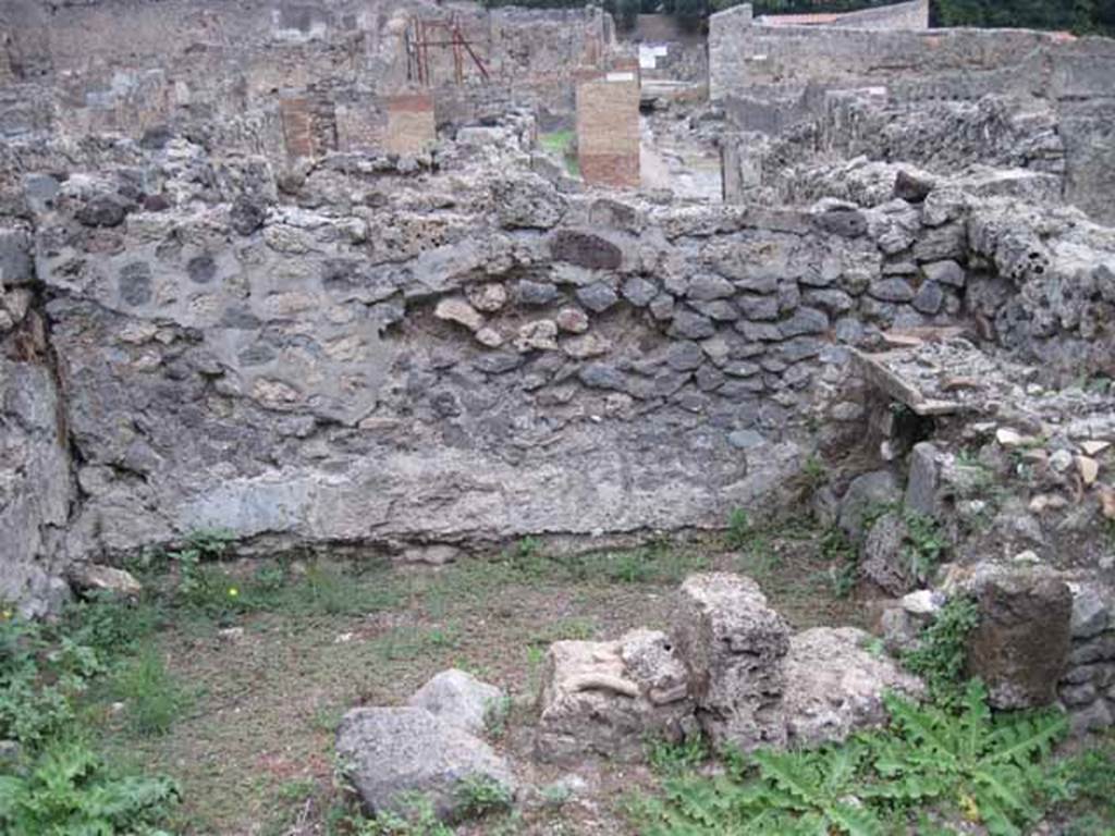 VIII.7.11 Pompeii. September 2010. Kitchen on north side of corridor, with remains of hearth, on right. Looking east. Photo courtesy of Drew Baker.