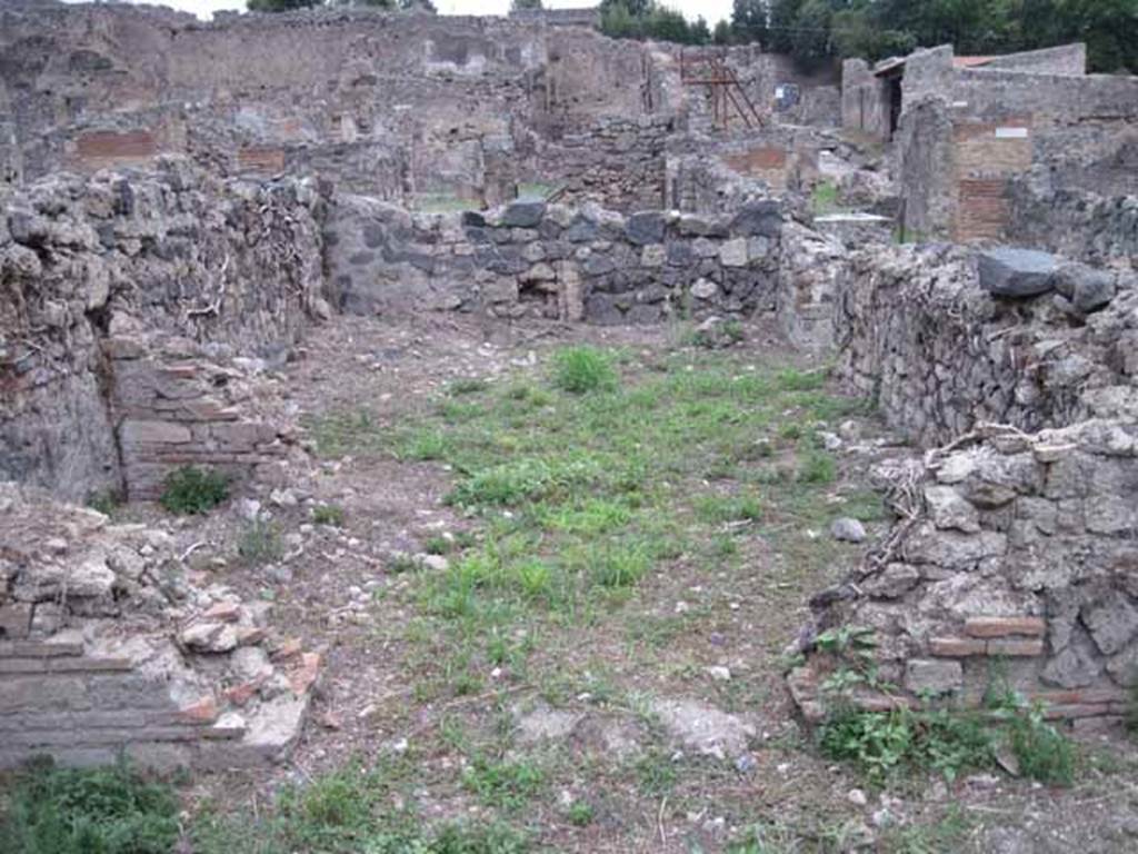 VIII.7.12 Pompeii. September 2010. 
Looking east into spacious triclinium fenestratum towards remains of wall with window, from the garden area. Photo courtesy of Drew Baker.
According to Mau –
“on the right (of the corridor) was a spacious triclinium, with two doors, one onto the corridor, one onto the locality at the end of it, which seems to have been a garden and at the end of which stands the wide entrance of a room not yet excavated, in the middle of which stands a brick column.”
See Bullettino dell’Instituto di Corrispondenza Archeologica (DAIR), 1875 (p.169).