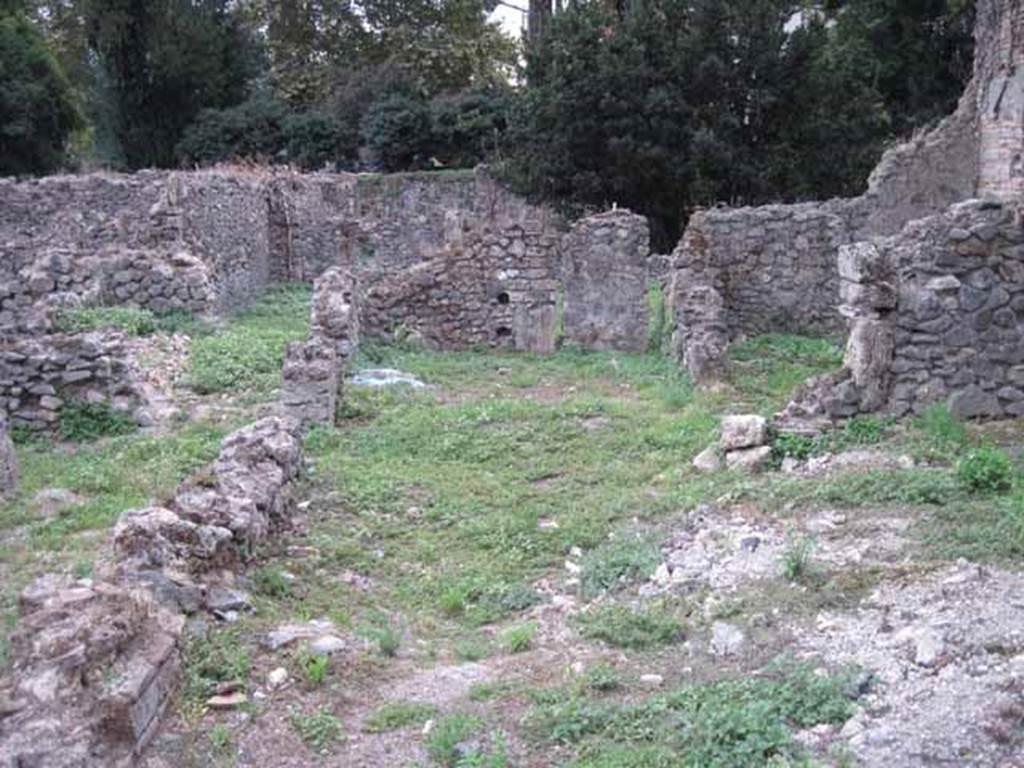 VIII.7.12 Pompeii. September 2010. Garden at rear, looking south towards linked garden of VIII.7.11, blocked doorway to garden of VIII.7.10 and city wall. Photo courtesy of Drew Baker.