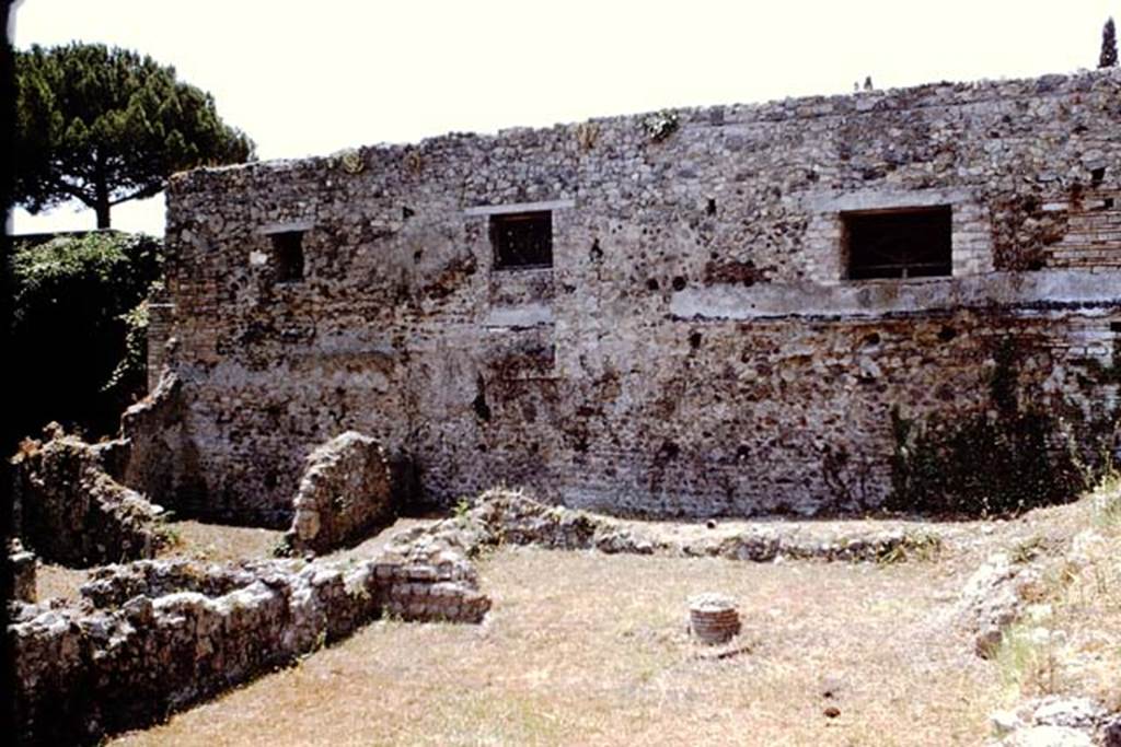 VIII.7.12 Pompeii. 1966. 
Garden area at rear, looking west towards base of column in wide entrance of room at rear. Photo by Stanley A. Jashemski.
Source: The Wilhelmina and Stanley A. Jashemski archive in the University of Maryland Library, Special Collections (See collection page) and made available under the Creative Commons Attribution-Non Commercial License v.4. See Licence and use details.
J66f0203
According to PARP:PS – there was a hearth/cooking facilities (no.6 on their plan) against the north wall in the rear area.
The remains of this can be seen on the right of the above photo.
