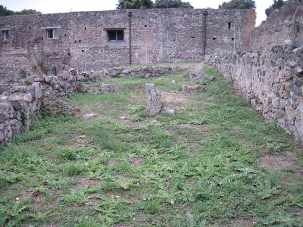 VIII.7.14 Pompeii. September 2010. Looking west across shop, to small rear room on left, and site of corridor with steps to upper floor and kitchen area, on right. Photo courtesy of Drew Baker.