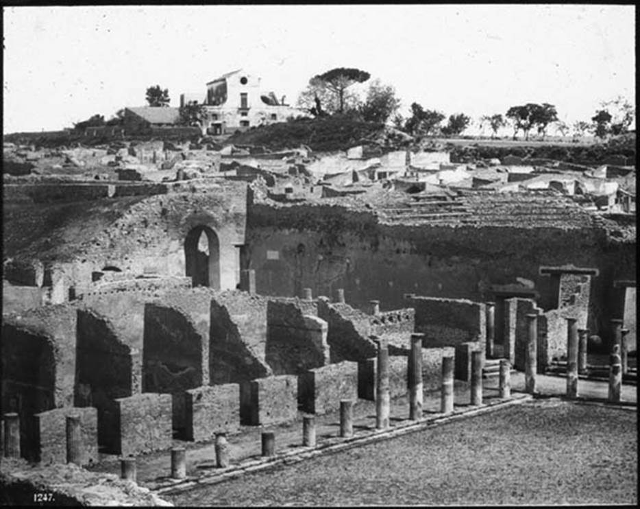 VIII.7.16 Pompeii. Photo possibly by Sommer and Son. Looking north-east across north end of Gladiator’s Barracks towards the Large Theatre, from Triangular Forum. 
Used with the permission of the Institute of Archaeology, University of Oxford. File name instarchbx208im 091. Resource ID. 44417.