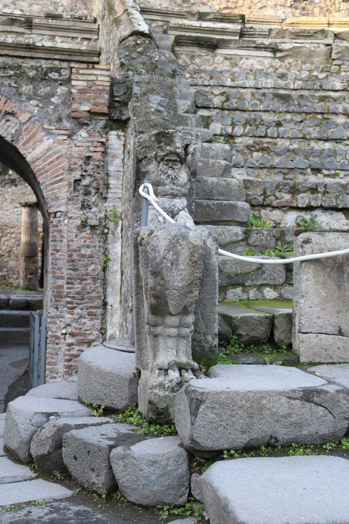 VIII.7.19 Pompeii. December 2018. 
Statue of Kneeling Atlas, with a tufa Lion’s foot in front, on west side near exit/entrance.
Photo courtesy of Aude Durand.