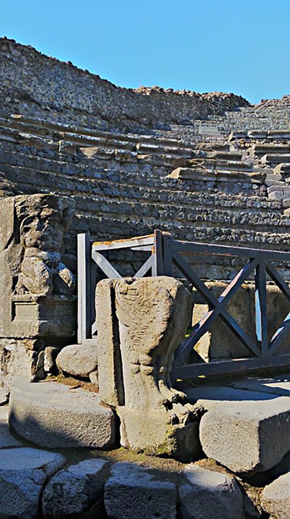 VIII.7.19 Pompeii. 2015/2016. West side near exit/entrance.
Statue of Kneeling Atlas, with a tufa Lion’s foot in front.  
Photo courtesy of Giuseppe Ciaramella.
