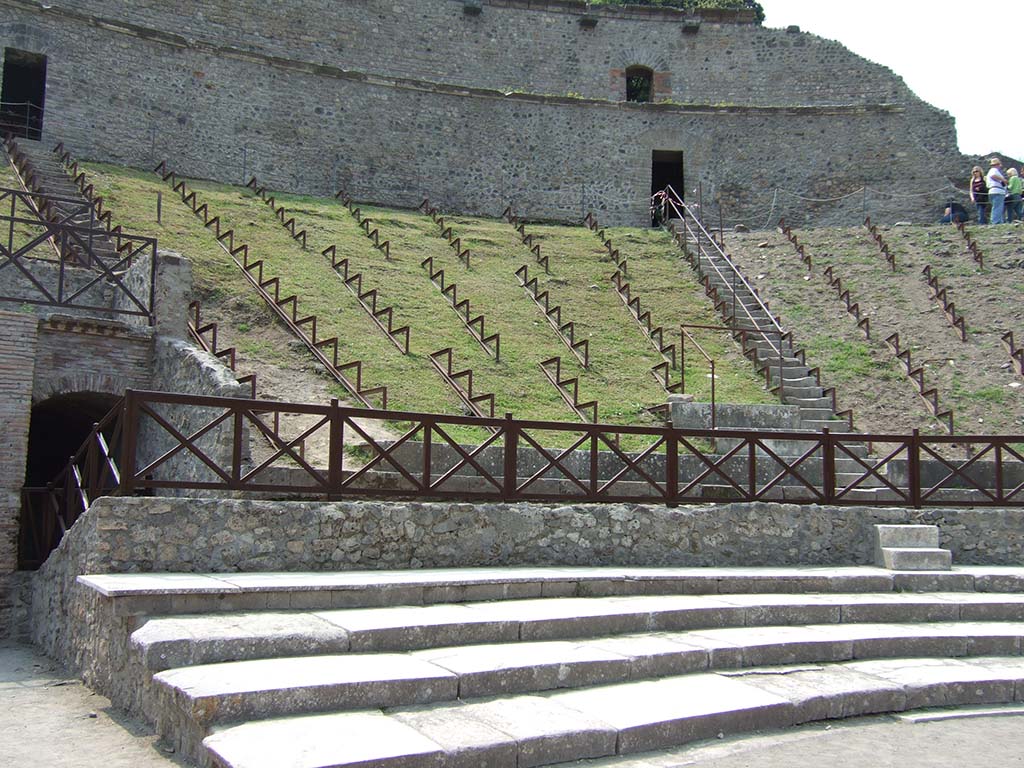 VIII.7.20 Pompeii. May 2006. The four ledges at the front were known as the ima cavea.
Members of the city council, the decurions, had the right to sit here on a seat of double width.