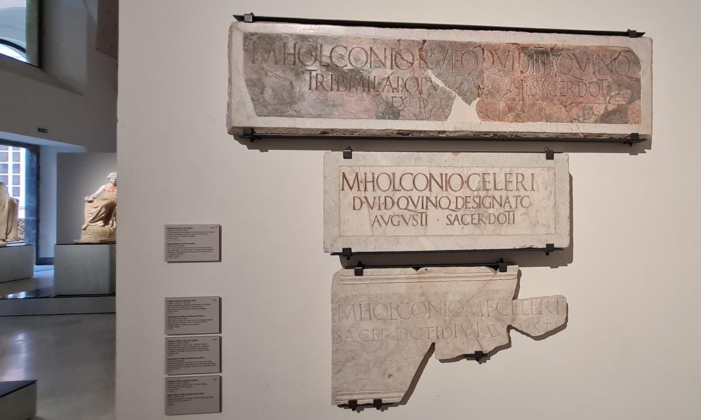 VIII.7.20 Pompeii. April 2023. Detail of the lower three Dedications, as seen on the descriptive notice-card, above. 
Photo courtesy of Giuseppe Ciaramella.