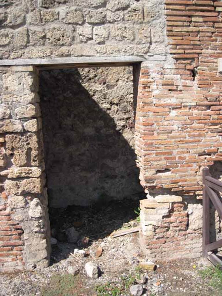 VIII.7.23 Pompeii. September 2010. Doorway to latrine, on east end of north wall, near shop entrance doorway. Photo courtesy of Drew Baker.