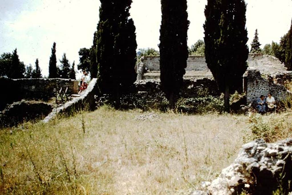 VIII.7.26 Pompeii. 1959. Looking west from garden area, towards upper level of Theatre, with Tatiana Warscher and Wilhelmina Jashemski resting in the shade.  Photo by Stanley A. Jashemski.
Source: The Wilhelmina and Stanley A. Jashemski archive in the University of Maryland Library, Special Collections (See collection page) and made available under the Creative Commons Attribution-Non Commercial License v.4. See Licence and use details.
J59f0262