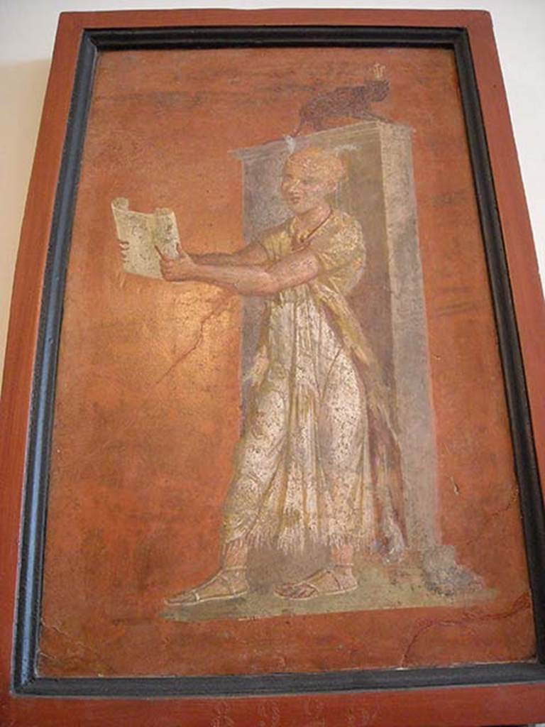 VIII.7.28 Pompeii. East part of north wall of portico. 
Priest reading ritual formulae from a papyrus scroll held in his hands. 
Now in Naples Archaeological Museum. Inventory number 8925.