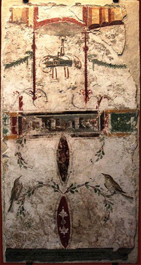 VIII.7.28 Pompeii. Part of the portico? Painting with basket, two birds and a landscape.
In the upper part a basket is suspended between two garlands, possible allusion to one of the rites of the cult to Bacchus, in which sacred objects were transported in baskets. 
At the bottom are two birds delicately landed in branches. 
The frame with a landscape placed in the centre was added later, perhaps to fill the space then empty. 
Now in the Museu Nacional/UFRJ Brazil.
Following the disastrous fire at the Museum on 3rd September 2018 this may have been destroyed.
Este afresco aproxima-se estilisticamente das pinturas de Herculanum e de Stabies. Apresenta na parte superior um cesto suspenso entre duas guirlandas, possível alusão a um dos ritos do culto a Baco, em que objetos sagrados eram transportados em cestos. Na parte inferior estão dois pássaros delicadamente pousados em ramagens. O quadro com uma paisagem colocado no centro foi acrescentado posteriormente, talvez para preencher o espaço então vazio. 
See http://www.museunacional.ufrj.br/dir/exposicoes/arqueologia/culturas-mediterraneo/arqcmed004.html