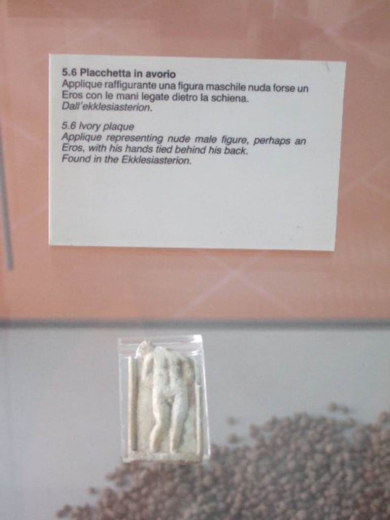 VIII.7.28 Pompeii. Found in the sacrarium or Ekklesiasterion. 
The Museum label says the Ekklesiasterion but the Museum website says the sacrarium.
Ivory plaque of male figure with hands tied behind his back. 
The presence of a wing, suggested by a ripple on the top-left margin, leads us to believe that this is a Cupid, represented according to the iconography of Eros punished, with the hands tied.
Now in Naples Archaeological Museum. Inventory number s. n. 7.